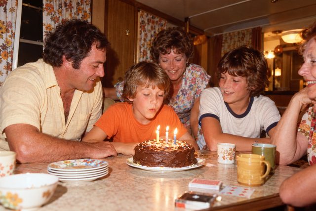 A small cake on a caravan table, photographed just before the candles went out.