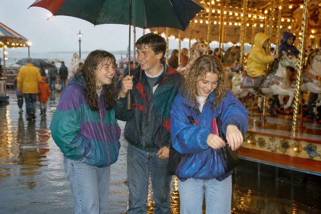 Cousins at the funfair, determined to enjoy themselves despite the weather.