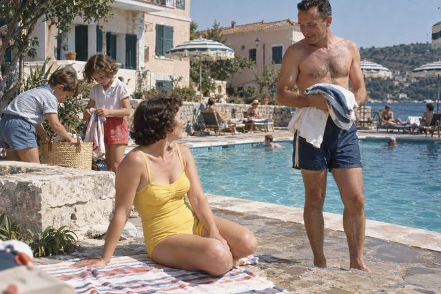 Sun-warmed paving, a striped parasol, and the first pool afternoon of the holiday.